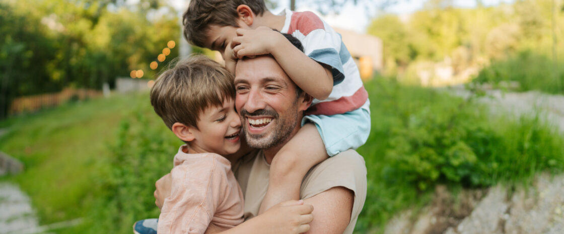 Portrait of a single father spending some quality time with his boys outdoors.