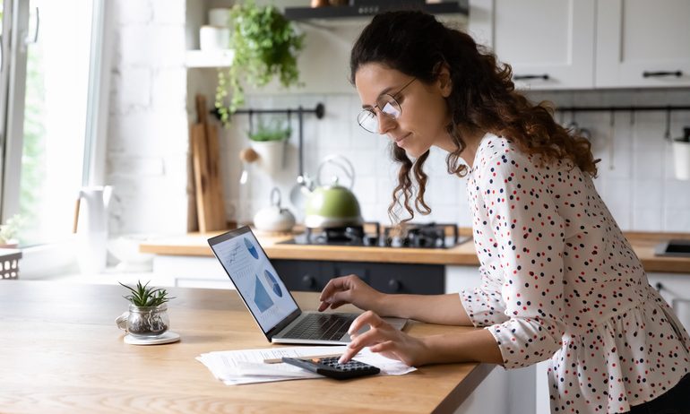 Person using laptop at counter.