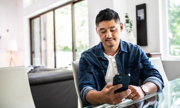 Man using mobile device at home