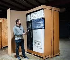 Person standing in front of Value Flex crate from Two Men and a Truck