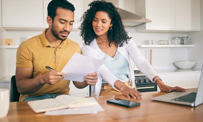 Two people looking at papers at desk