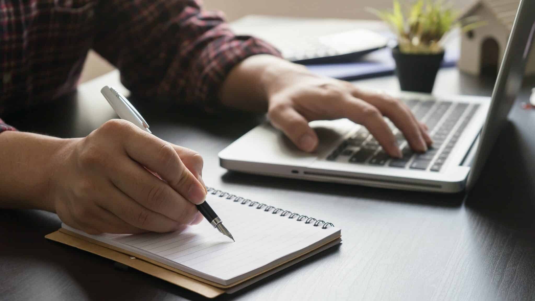 Close up of person working on laptop, improving their credit score