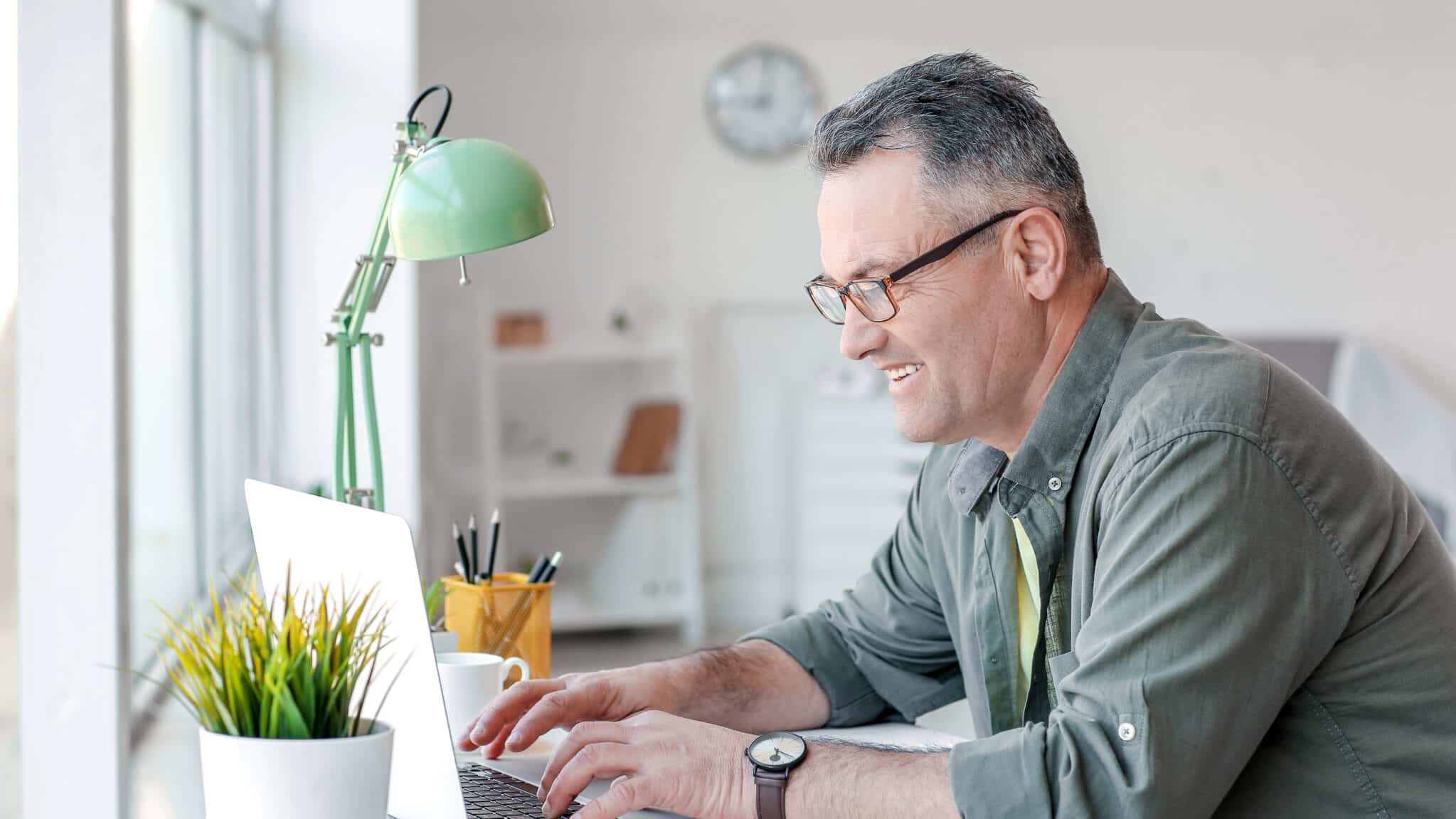 Mature man learning on laptop, obtaining certificates through Money Fit's online bankruptcy counseling and debtor education services