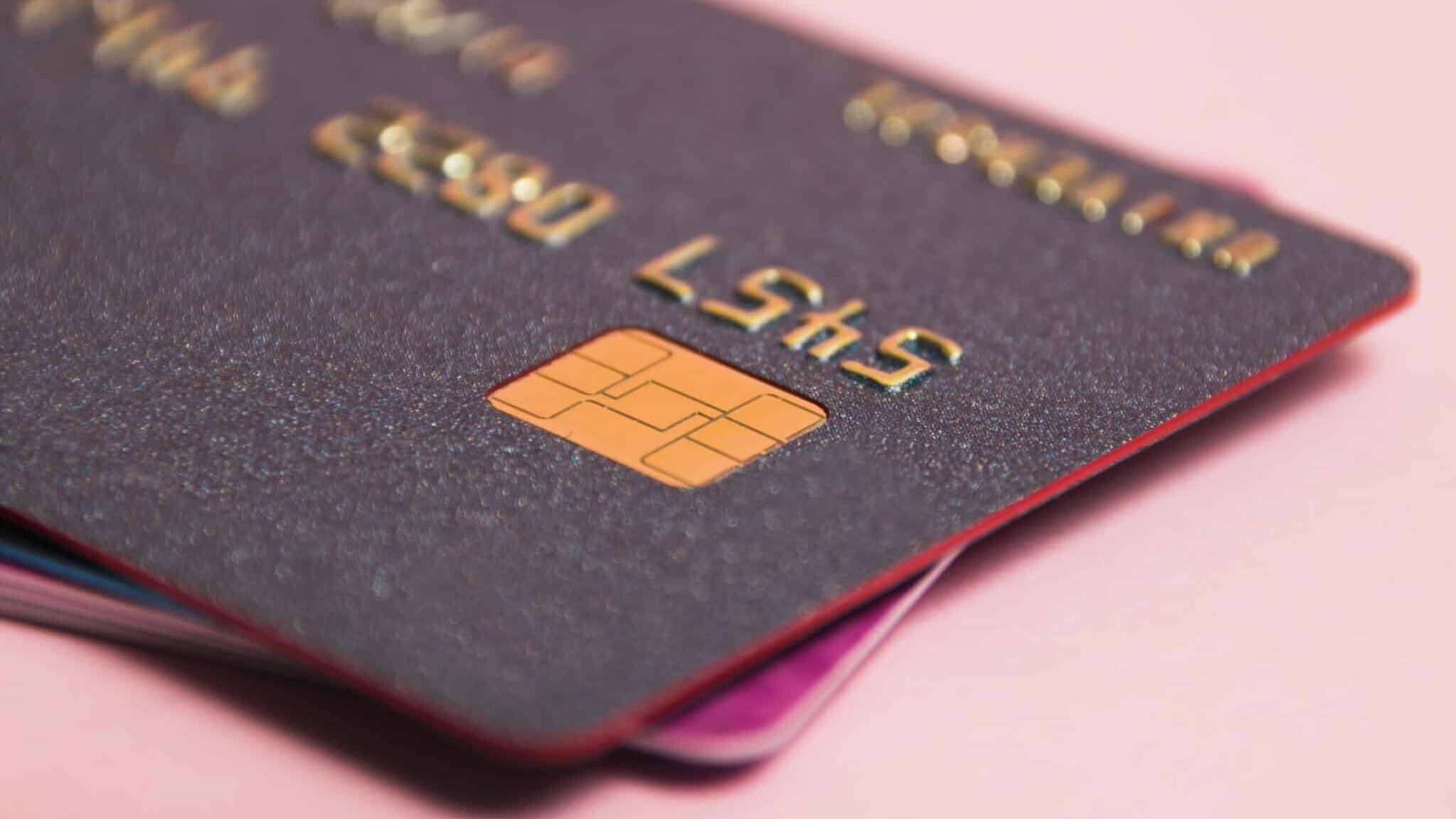 modern bank cards with chips macro, credit cards on a pink background. the concept of bank card payments.