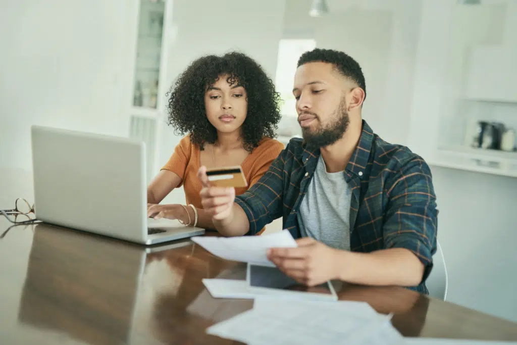 Couple reviewing their credit card debt together and deciding how to deal with it