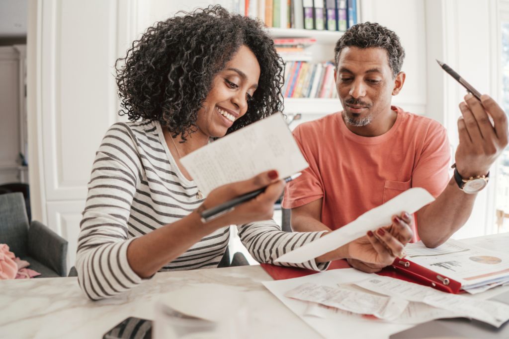 Couple reviewing a household budget together at a table