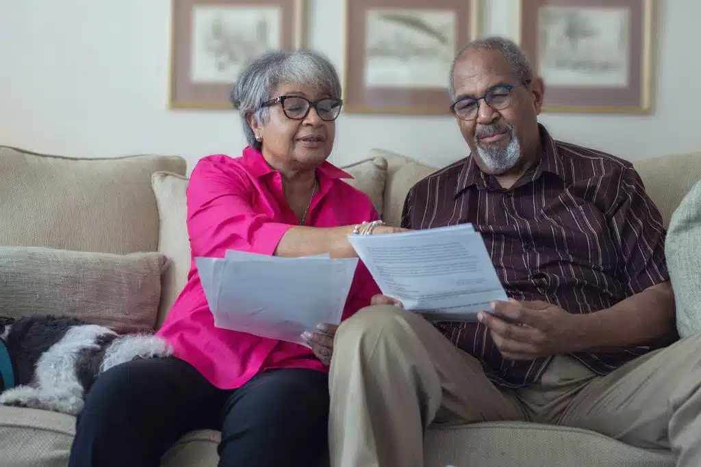 Older couple reviewing financial information together in a calm, supportive setting