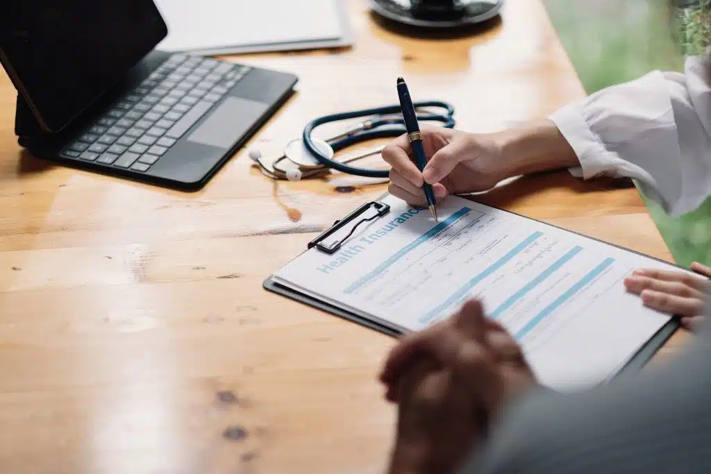 Woman reviewing health insurance plan options on her laptop