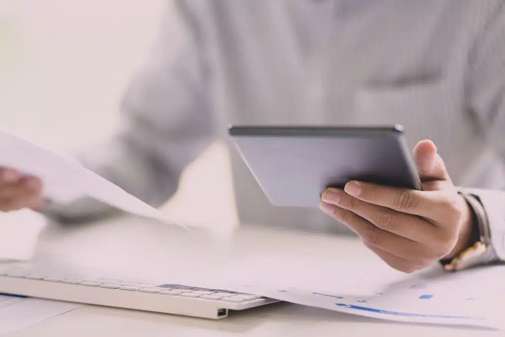 Man comparing loan options on his laptop at home