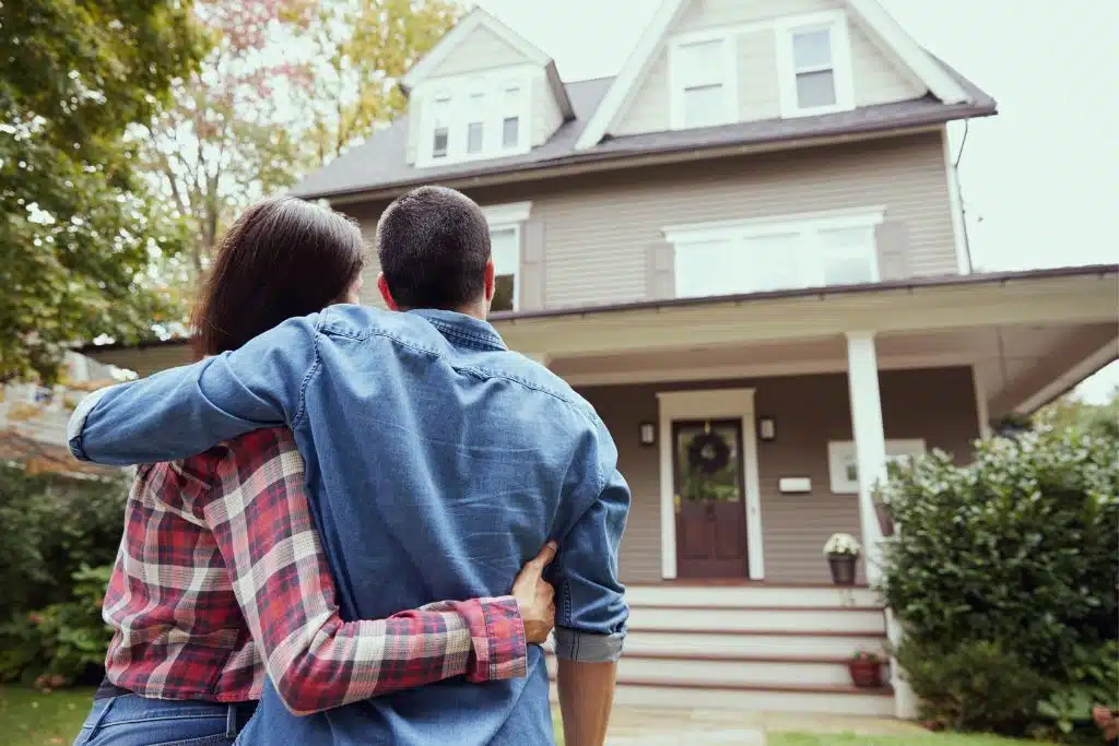 Young couple reviewing savings goals for a home down payment